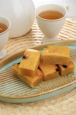 Dilimlenmiş Prol Bant veya Bolu Tapai beyaz tabakta. Prol Bant Endonezya 'dan geleneksel bir pasta, mayalanmış Cassava' dan yapılmış, ızgara peynir ve fırında pişirilmiş