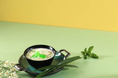 Buko Pandan is a Drink Originally from Philippines, Made from  Jelly, Young Coconut, Evaporated Milk, Sweetened Condensed Milk, Served on Black Bowl, Copy Space