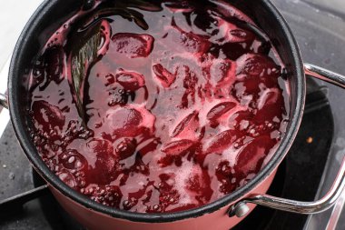 Close Up Cooking Process making Manisan Kolang kaling with Red Food Coloring on the Stove. Cooking Process Step by Step in the Kitchen Making Ramadan breakfasting Dessert 