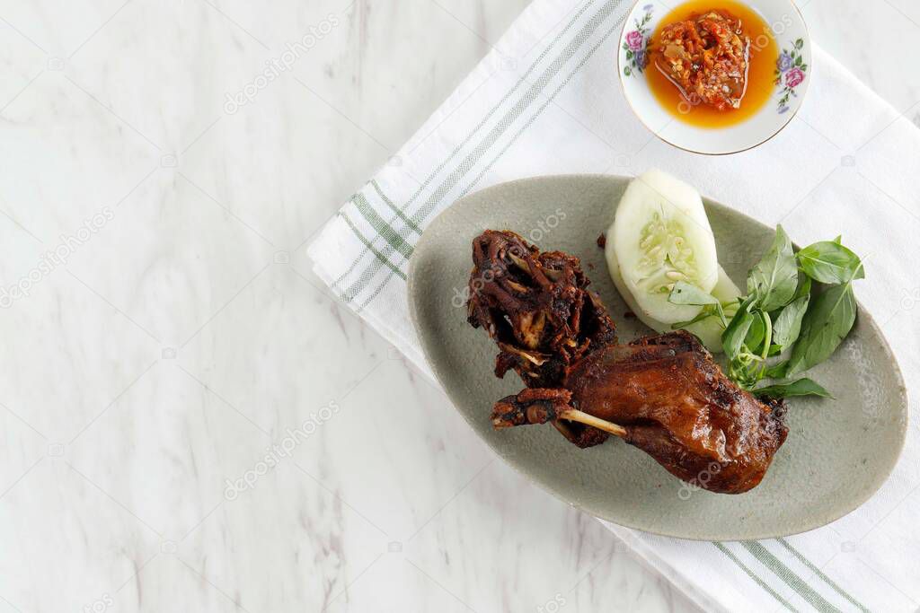 Bebek Goreng. Popular Indonesian Dish of Deep Fried Duck, Served with Red Chili Paste. Top View Copy Space for Text 