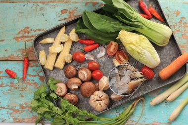 Tom Yam Kung (thai food) ,prawn with squid, kaffir lime leaves, galangal, coriander leaves, straw mushrooms