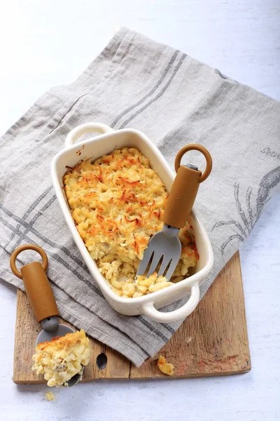 Homemade Macaroni and Cheese  for Kids. Made from Macaroni and Shredded Cheese, Served on Cream Baking Dish