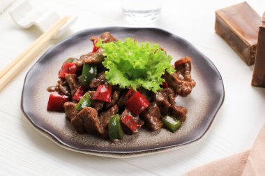 black pepper beef with chopped paprica and onion