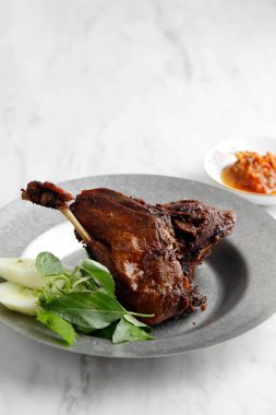 Bebek Goreng Hitam, Deep Fried Duck with Black Spices, Popular in Madura and Surabay Indonesia. Usually Served with Sambal and Fresh Vegetable