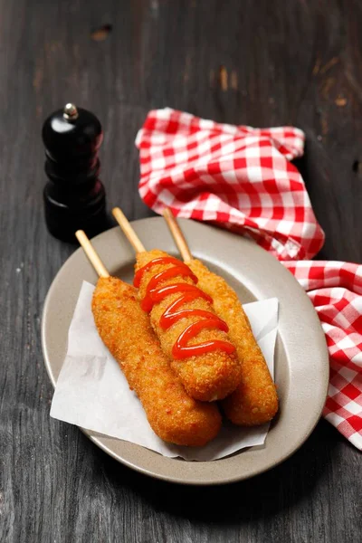 Corn Dog is a Sausage on a Stick with Mozarella Cheese, Coated with FLour Batter and Deep Fried. Hotdog Korean Street Food