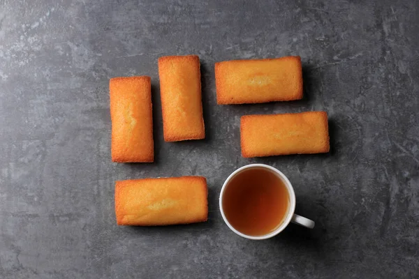 Top View French Biscuits Called Financiers, with Almond Powder, Smooth Inside and Crispy on the Edges, Copy Space for Text, Served with Tea