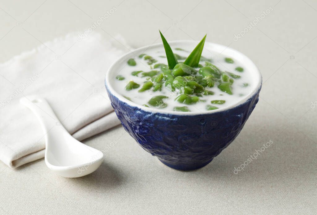 Es Cendol or Dawet is Indonesia Traditional Iced Dessert Made from Rice Flour, Palm Sugar, Coconut Milk and Pandan Leaf Served in a Blue Bowl. Popular during fasting in Ramadan.