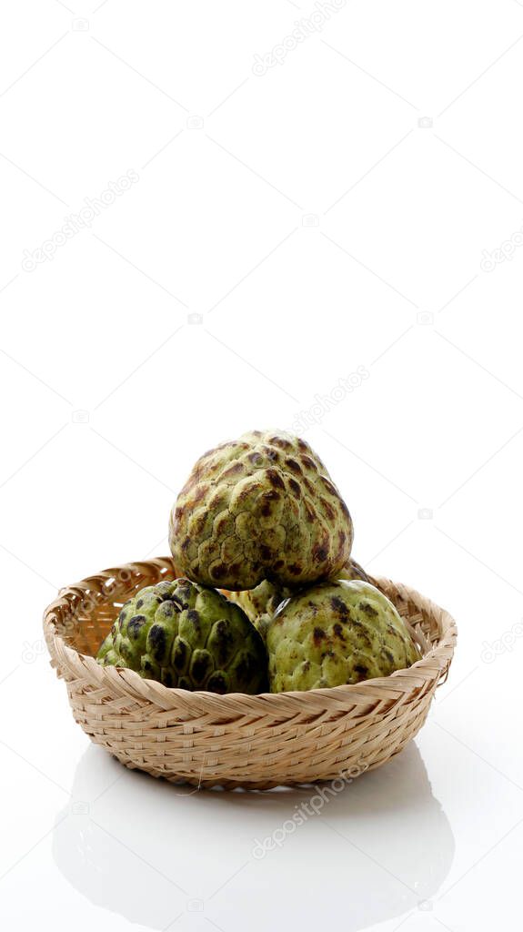 Fresh Sugar Apple fruit or Custard Apple or annona cherimoya ,sweetsop in basket with white background isolated