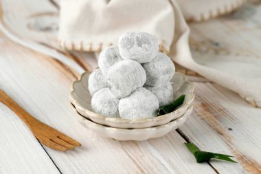 Delicious Mochi in Mini Bowl on Light White Wooden Rustic Table with Bamboo Fork. Traditional Japanese Dessert clipart