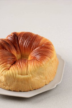 Taze pişmiş Wool Roll Ekmeğini, Ev Yapımı Viral Ekmeği Yün Gibi Güzel Dokuya sahip. Gri Tabakta servis edildi