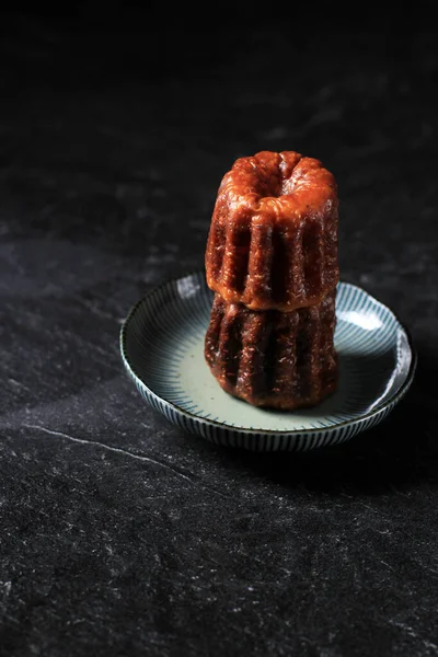 Canele ya da Cannele, Bordeaux 'dan Fransız Pastası. Rom ve vanilya aromalı krema ve kalın karamelize kabuklu. Mini Plaka, Kopya Boşluğu ile Siyah Arkaplan