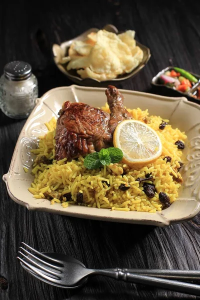 Nasi Briyani or Biryani Rice with Roast Chicken  Typical Middle East Food. Basmati Rice Cooked with Spices. Similar with Kabli, Kebuli, Mandhi, Kabsah Rice. Selected Focus