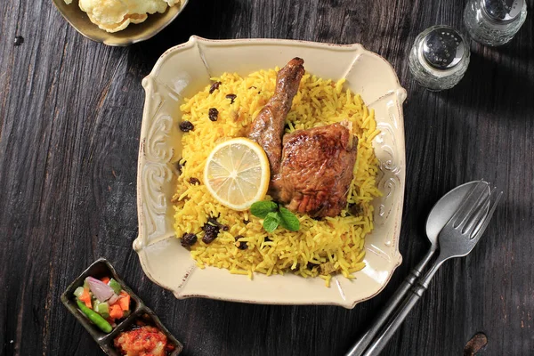 Delicious Chicken Biryani  On Ceramic Plate. Briyani Dish Beautiful Indian Rice Dish. Delicious Roast Spicy Chicken biryani in Square Plate Over Moody Background, Popular Indian, Arab, and Pakistani.