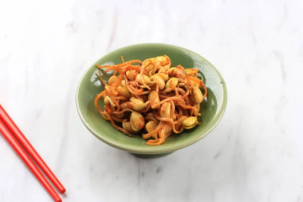 Korean Dish: Kongnamul Muchim, One Various of Spicy Korean Side Dish (Banchan). Kongnamul is Mung Bean Sprout. Serve on Side Dish Plate on Marble Table with Copy Space for Text