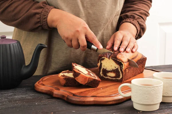 Slicing Marble Cake, Female Baker Hold Knife to Cut Loaf Marmer Cake in the Kitchen, About to Serve with Tea for Afternoon Tea Time