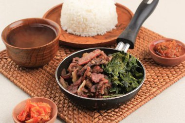 Sei Sapi or Beef Sei is Indonesia Traditional Smoked Beef, Served with Boiled Cassava Leaves and Sambal Luat or Sambal Matah. Typically Food from Nusa Tenggara, Indonesia. clipart