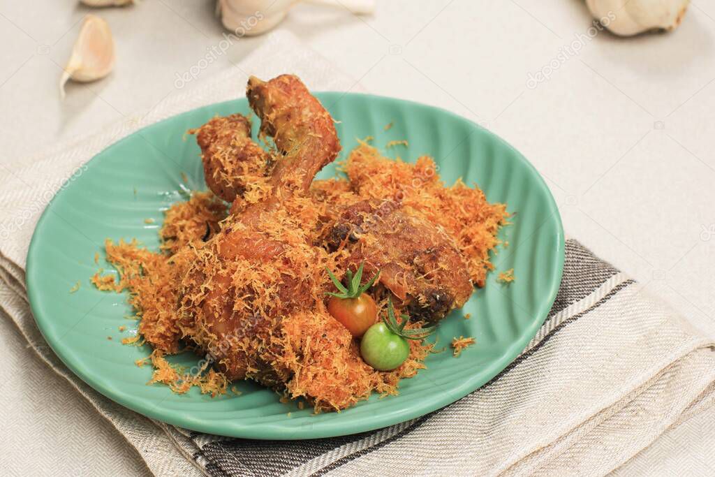 Close Up Ayam Serundeng (Ayam Lengkuas) , Indonesian Traditional Fried Chicken Recipe with Shredded Coconut.