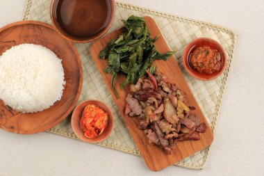 Se'i Sapi or Beef Sei is Indonesia Traditional Smoked Beef, Served with Boiled Cassava Leaves and Sambal Luat or Sambal Matah. Typically Food from Nusa Tenggara, Indonesia clipart