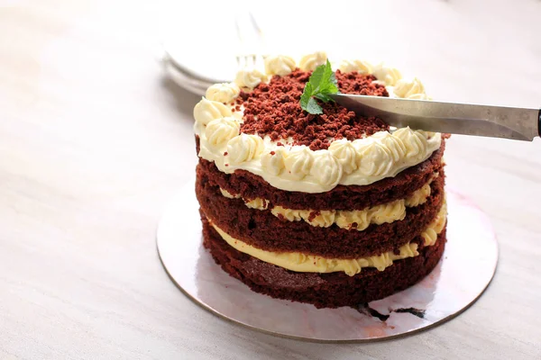 Slicing Red Velvet Cake, Classic Three Layered Cake from Red Butter Sponge Cakes with Cream Cheese Frosting, American Cuisine