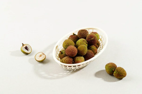 Fresh Green Lychee Fruit Plastic Basket Cream Background Copy Space — Stok Foto