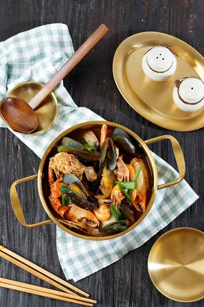 Mix Asian Seafood Soup with Prawns, Mussels, Crab,  and Clams, Served on Gold Utensils