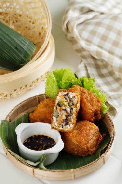 Stuffed Fried Tofu or Gehu or Tahu Isi Served with Spicy Sweet Soy Sauce. Indonesian Popular Street Food Stall