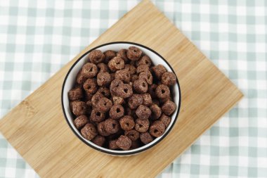 Chocolate Cereal Ring on Ceramic Bowl, Top View