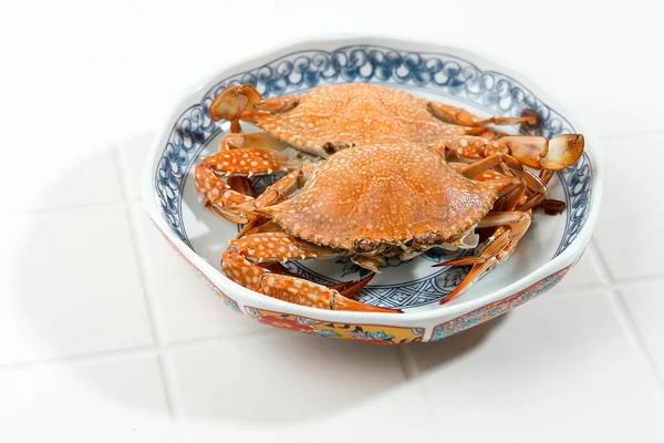Steamed Blue Crab or Rajungan Served on Chinese Ceramic Plate on White Background, Food Preparation. Copy Space for Text