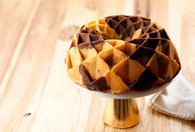 Marble Chocolate Butter Cake,  Old Recipe Marmer Cake Jadul on Cake Stand, Wooden Table. Copy Space for Text