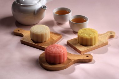 Colorful Snow Skin Moon Cake, Sweet Mochi Mooncake, Traditional Sweet Dessert for Mid Autumn Festival, Served with Tea. Copy Space for Text