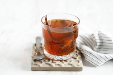 Wedang Uwuh, Traditional Warm Drink from Yogyakarta with Red Color.  Made with Various Spice. Copy Space for Text or Advertisement 