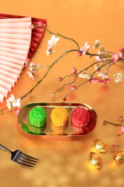 Colorful Snow Skin Moon Cake, Sweet Mochi Mooncake, Traditional Chinese Dessert for Mid-Autumn Festival. On Gold Plate