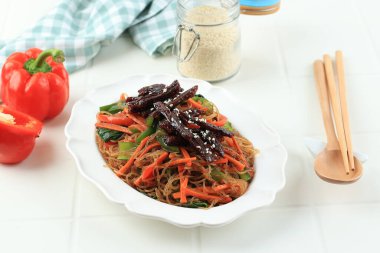 Japchae or Chap Chae,  Korean Glass Noodle Dish with Beef Bulgogi and Sesame Seed Topping 
