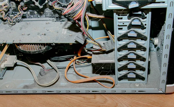 A thick layer of dust covers the internal electronic components of the old computer, Thick dust on the electronic components it is nasty, close up.