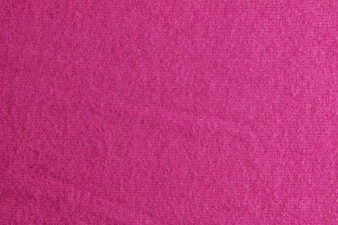 Leylak pembesi örülü halı yakın plan. Leylak pembesi arkaplanda tekstil dokusu. Ayrıntılı sıcak iplik arka planı. Doğal yün kumaş, süveter parçası..