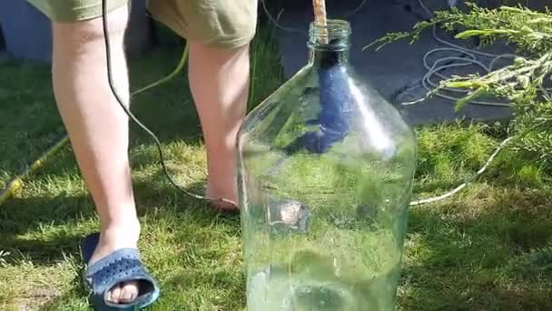 Man Washes Glass Twenty Liter Bottle Narrow Neck Electric Drill — Stock Video