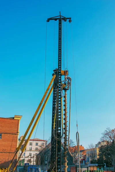 Hydraulic drilling rig. Installation of bored piles with a casing string. Foundations and grounds. Drilling in the ground. technology. Machine for drilling holes in the ground.