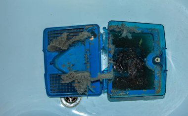 Dirty water filter after vacuuming with a water filter. Maintenance of home appliances.