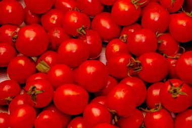 Red ripe tomatoes as background, closeup. Food backgrounds concept
