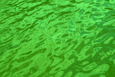 Iillustration of water ripple texture background. Wavy water surface during sunset, golden light reflecting in the water.