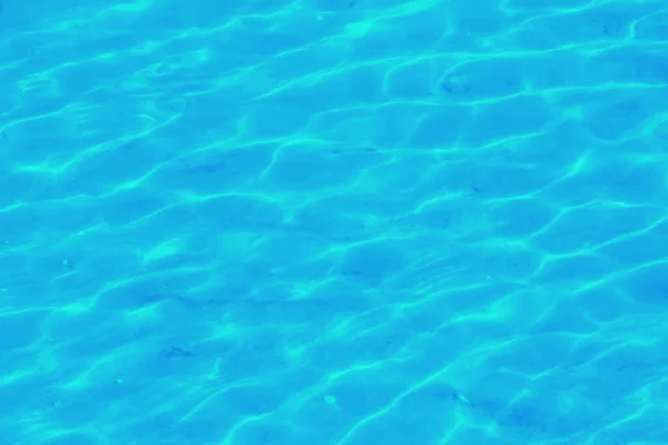 Water ripple texture background. Wavy water surface. Blue sky reflected in the water.