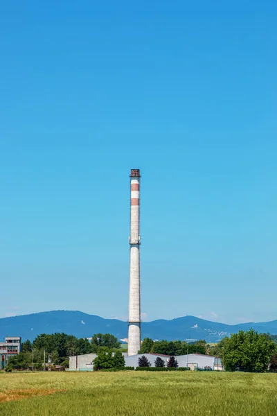 View en exhaust pipe of an industrial plant against the blue sky. The company is not working. There are no exhaust gases. Energy crisis.