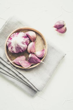 Eski ahşap arka planda kırsal tarzda sarımsak. Taze soyulmuş mor sarımsak. Üst görünüm.