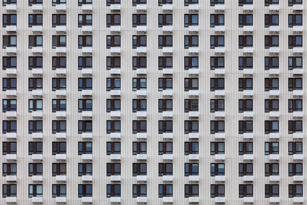 Background image - a wall of a multi-storey building with the same windows
