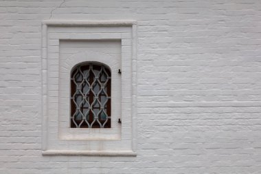 Background image - white monastery wall with a window.