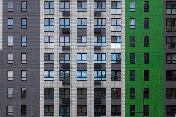 Background image - a fragment of a multi-colored wall of a modern building.