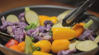 Cooking mixed vegetables, a shot of waves in the ocean, this footage is for you to grade it the way you like it. It has low contrast and a wash color for you to post process it.