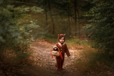 a child in the form of a fox walks in the woods