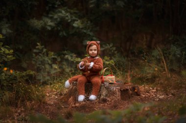 a child in the form of a fox walks in the woods