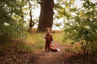 a child in the form of a fox walks in the woods
